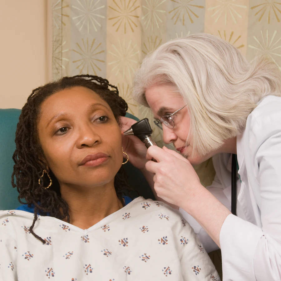 Otolaryngologist examining a patient's ear with an otoscope